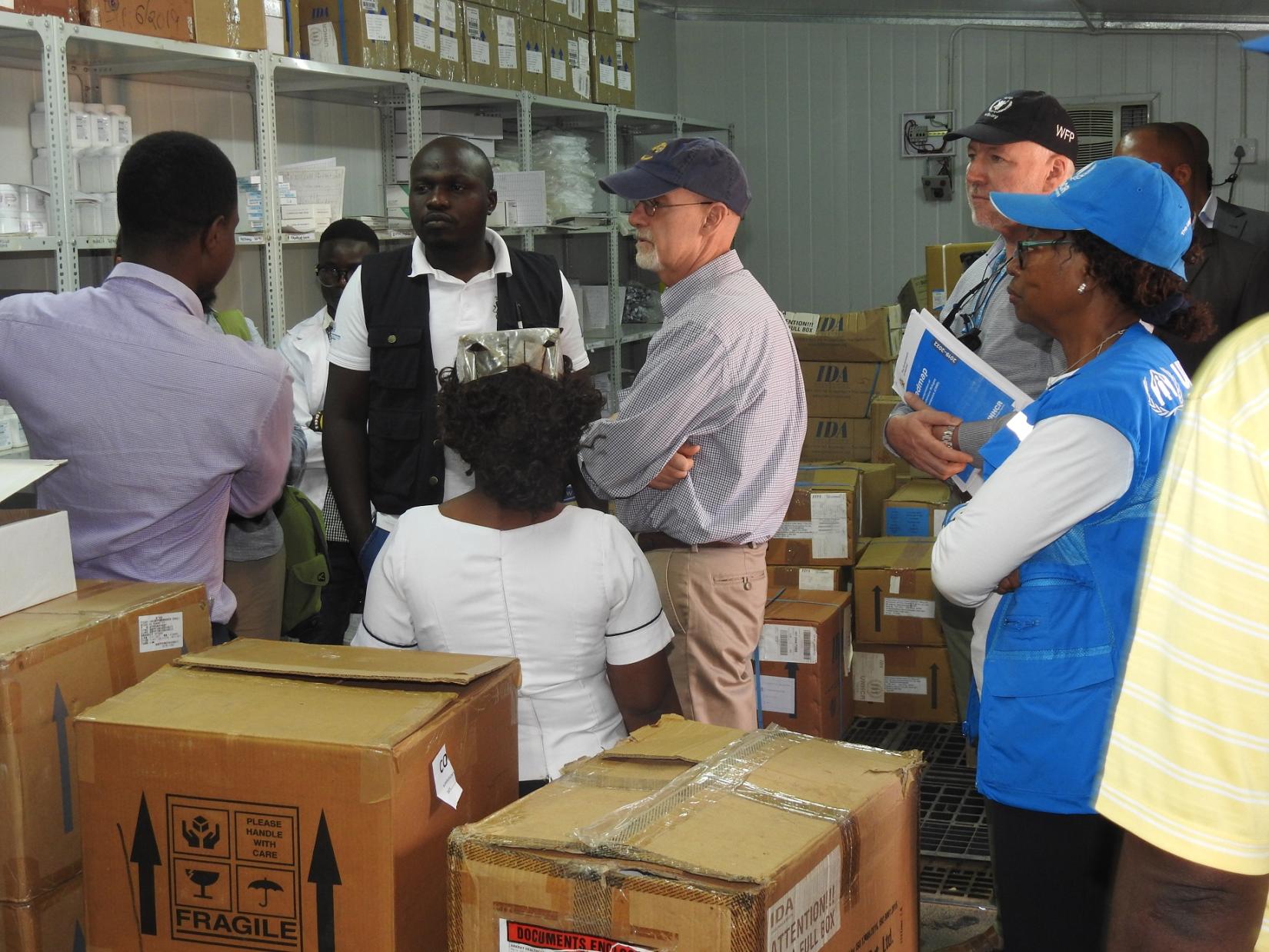 Ambassador Scott being briefed by medical staff at Dzaleka Health Centre.