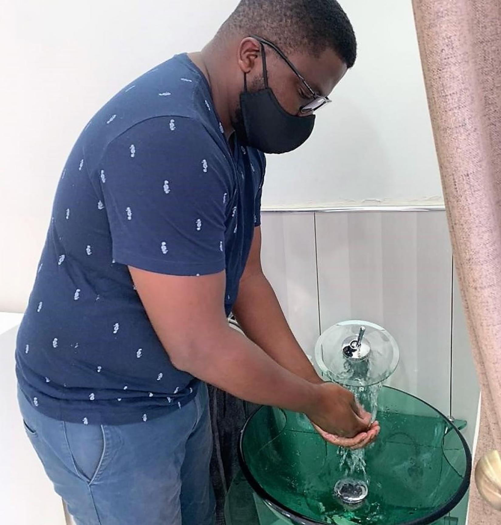 Rodrick handwashing at home, this is one of the preventative measures he has enhanced at home.