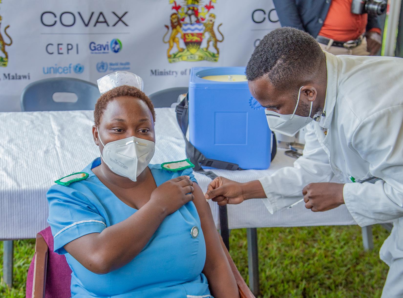 Monalisa Tembo, Senior Nursing Officer, Mzuzu Central hospital, gets the COVID-19 vaccine
