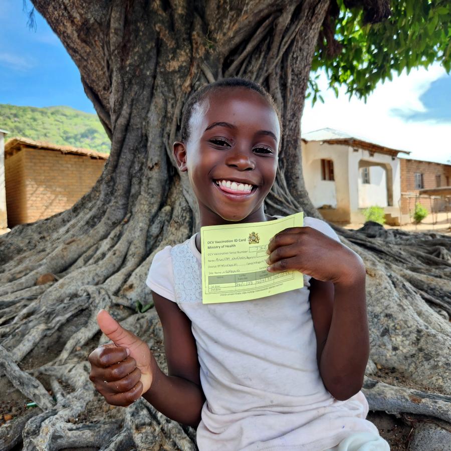 9-year-old Anita flashes her card after receiving the oral cholera vaccine at Nkhono Village in Mangochi. 