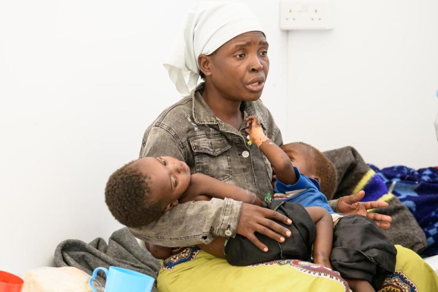Mariam Andrea holds her one-year-old sick twin boys Obed and Obadia